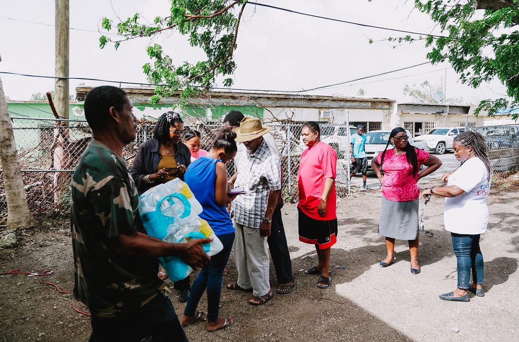Cane Bay Cares distributes water at the Boys and Girls Club in Frederiksted in the aftermath of Hurricane Maria. Photo Credit: http://nicolecanegata.com/