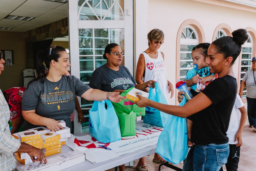 Cane Bay Partners volunteers distribute several thousand pounds of food, hundreds of LUCI solar lights and 6 pallets of water donated by St. Croix Foundation at Zion Christian Academy on Saturday, Nov. 11. Photo credit: Nicole Canegata http://nicolecanegata.com/