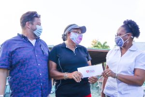 Scott Hensley and Rosemarie Mullgrav of Community First pose with Cane Bay Cares Manager Neisha Christopher-Christian after receiving a Cares donation at their renovation site, the former Villa Morales restaurant.